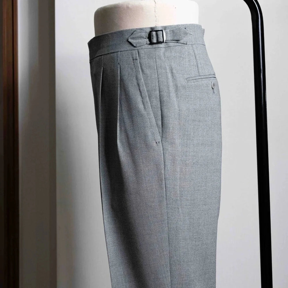 Side view showing the elegant leg line, side seam, and natural movement of the mid-grey wool.