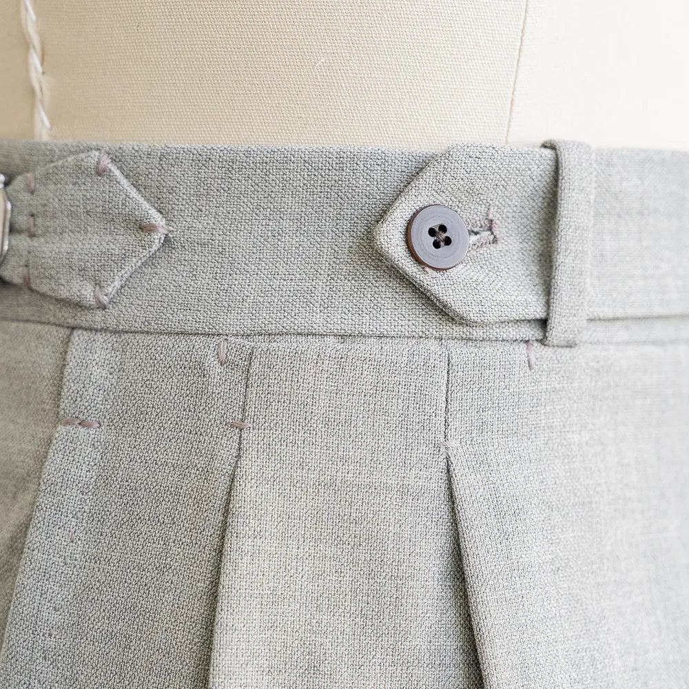 Close-up of the front pleat or flat-front construction showing crisp structure and refined tailoring.