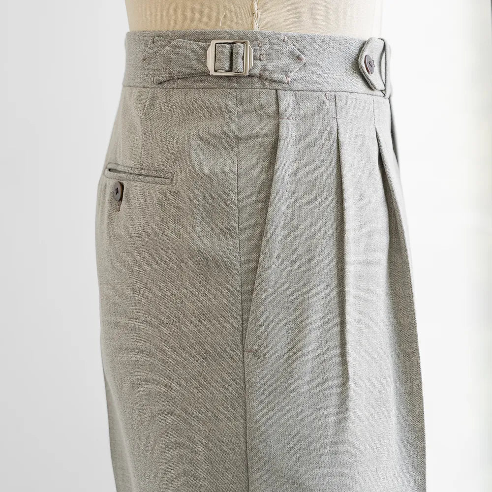 Close-up of the extended waistband, button, stitching, and Drapers wool texture.