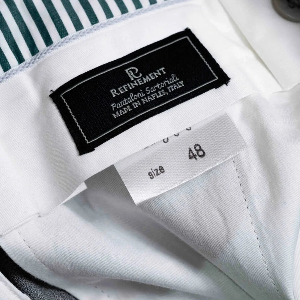 Close-up of the interior label showing Refinement branding and Drapers cloth identification.
