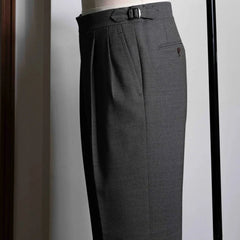 Side view showing the leg shape, side seam, and natural movement of the taupe-brown wool.