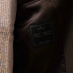 Close-up of the interior trousers label showing Refinement branding and Tallia di Delfino fabric marking.
