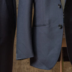 Close-up of the hem area showing the Dormeuil fabric label stitched on the RMJ-03 Navy Jacket.