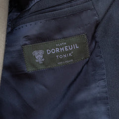 Close-up of the interior labels of the RMJ-03 Navy Suit by Dormeuil showing Refinement × Ring Jacket branding and Dormeuil fabric label.