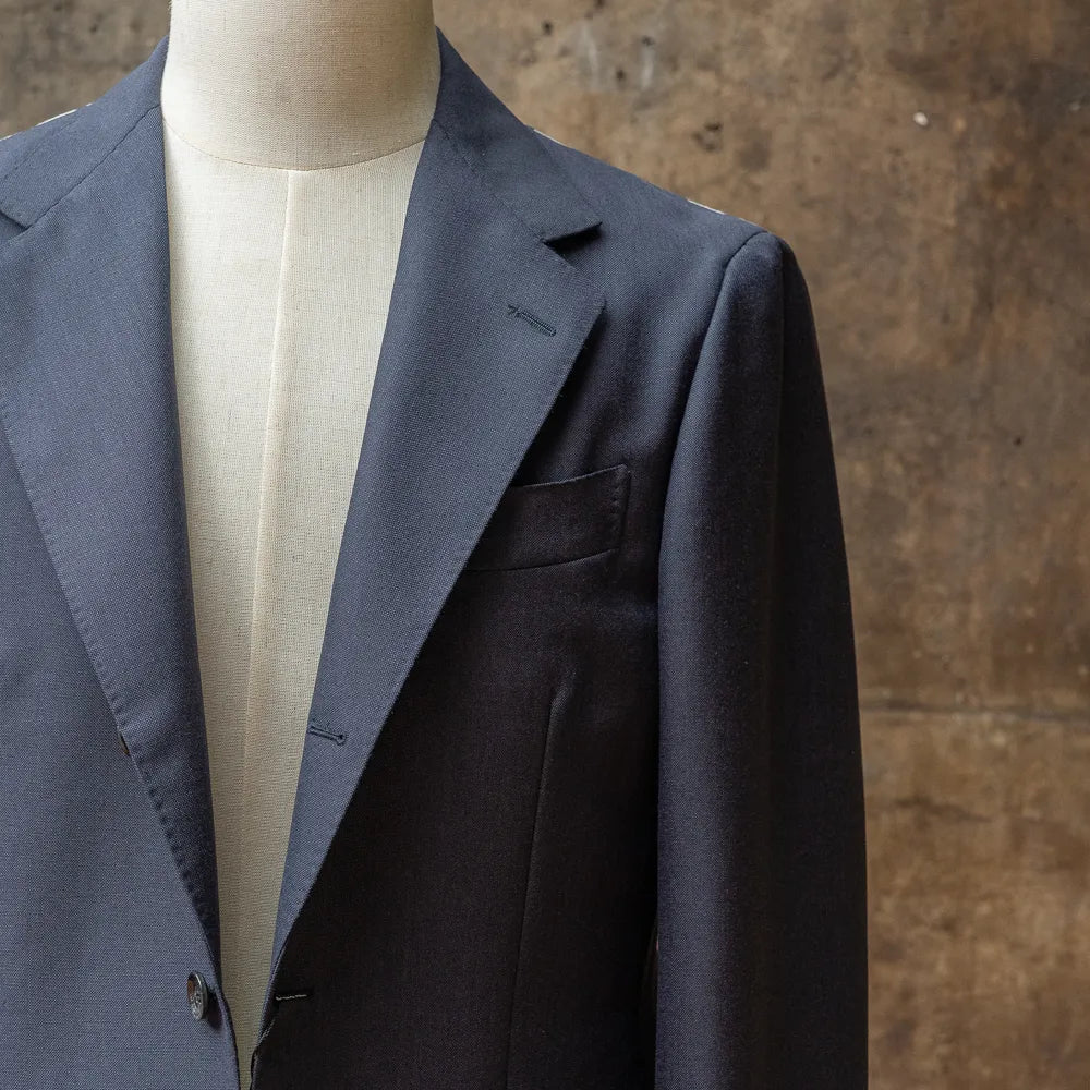 Close-up of the sleeve of the RMJ-03 Navy Jacket by Dormeuil showing button arrangement, stitching, and sleeve finishing.