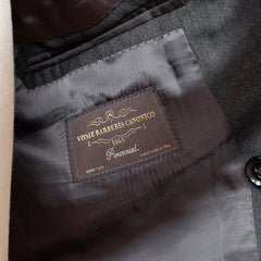 Close-up of the interior labels of the RMJ-04 Suit showing Refinement × Ring Jacket branding and Vitale Barberis Canonico fabric label.