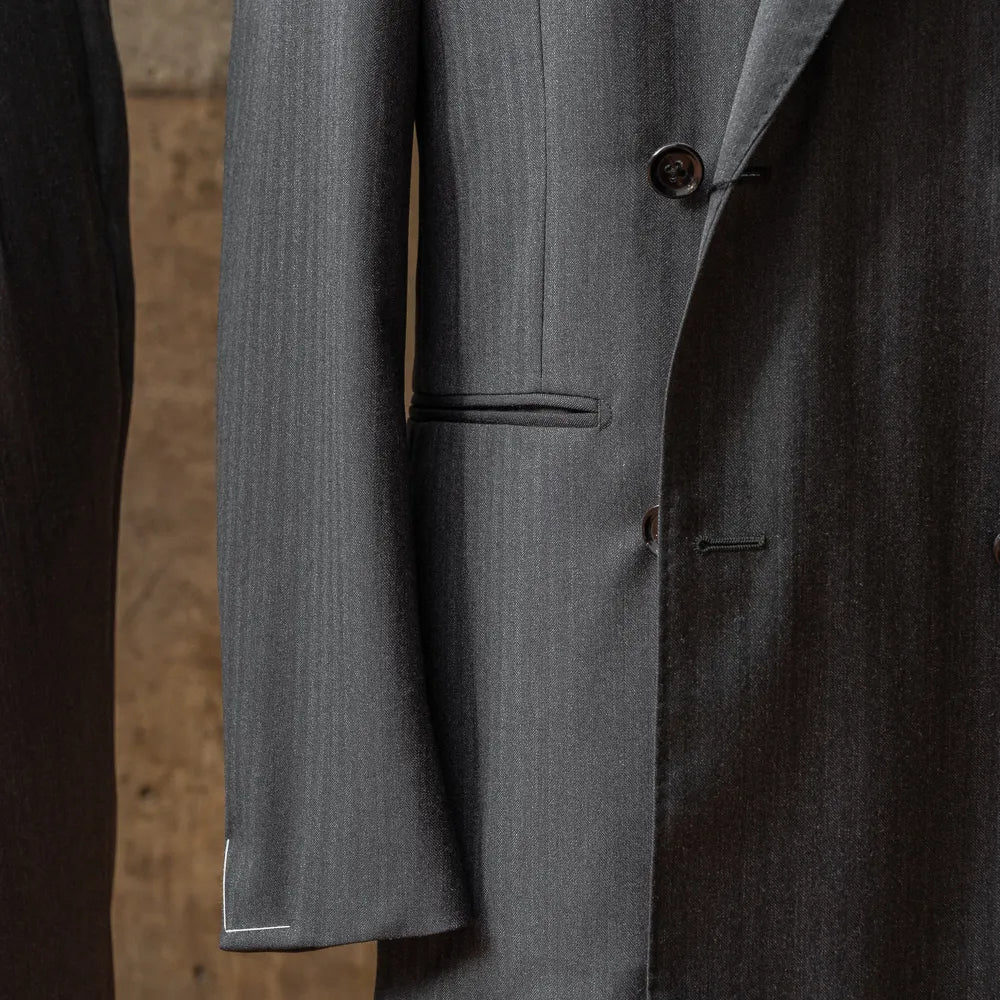 Close-up of the sleeve and hem of the RMJ-04 Double Breasted Jacket showing buttonwork, stitching, and clean finishing.