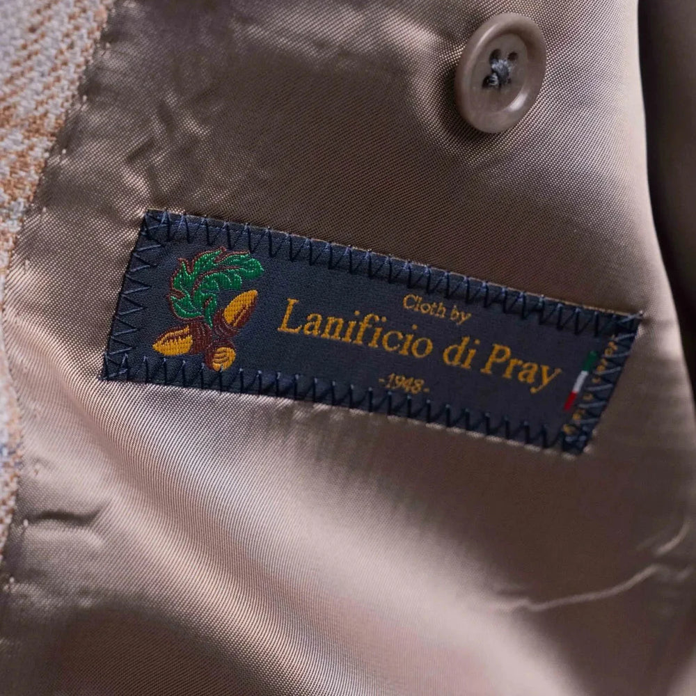 Close-up of the interior label showing Refinement Tailoring branding and Lanificio di Pray fabric marking.