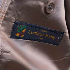 Close-up of the interior label showing Refinement Tailoring branding and Lanificio di Pray fabric marking.