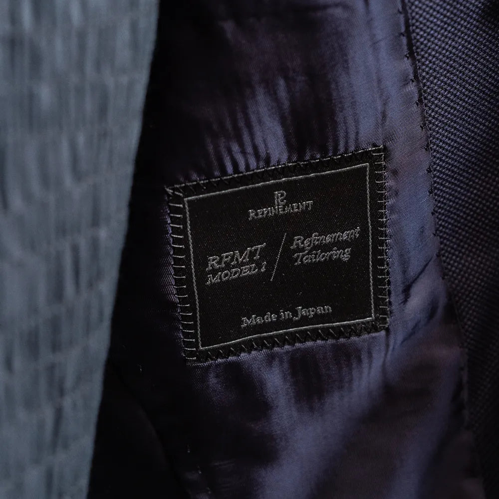Close-up of the Refinement Tailoring interior label and lining construction.