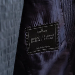 Close-up of the Refinement Tailoring interior label and lining construction.