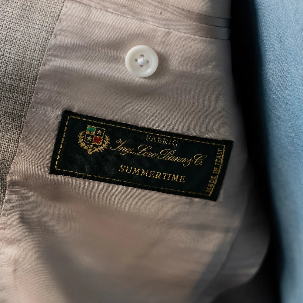Close-up of the interior Loro Piana Summertime fabric label, highlighting craftsmanship and cloth origin.