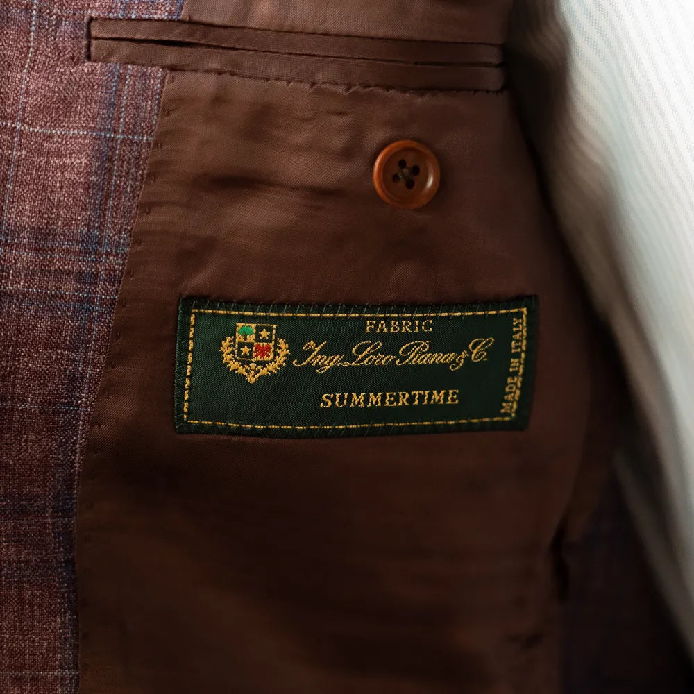 Interior close-up of the Loro Piana Summertime label, showing cloth origin and premium finishing.