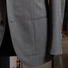 Close-up of the jacket front and hem highlighting natural drape and finishing.