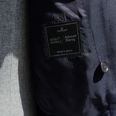 Close-up of the Refinement inner brand label stitched inside the blazer.