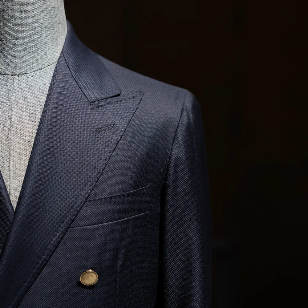 Close-up of the lapel roll and chest pocket showing clean tailoring lines.