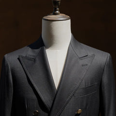 Upper front view highlighting the peak lapel shape and chest pocket detail.