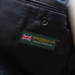 Close-up of the interior trousers label showing Refinement branding and Woodhead cloth marking.