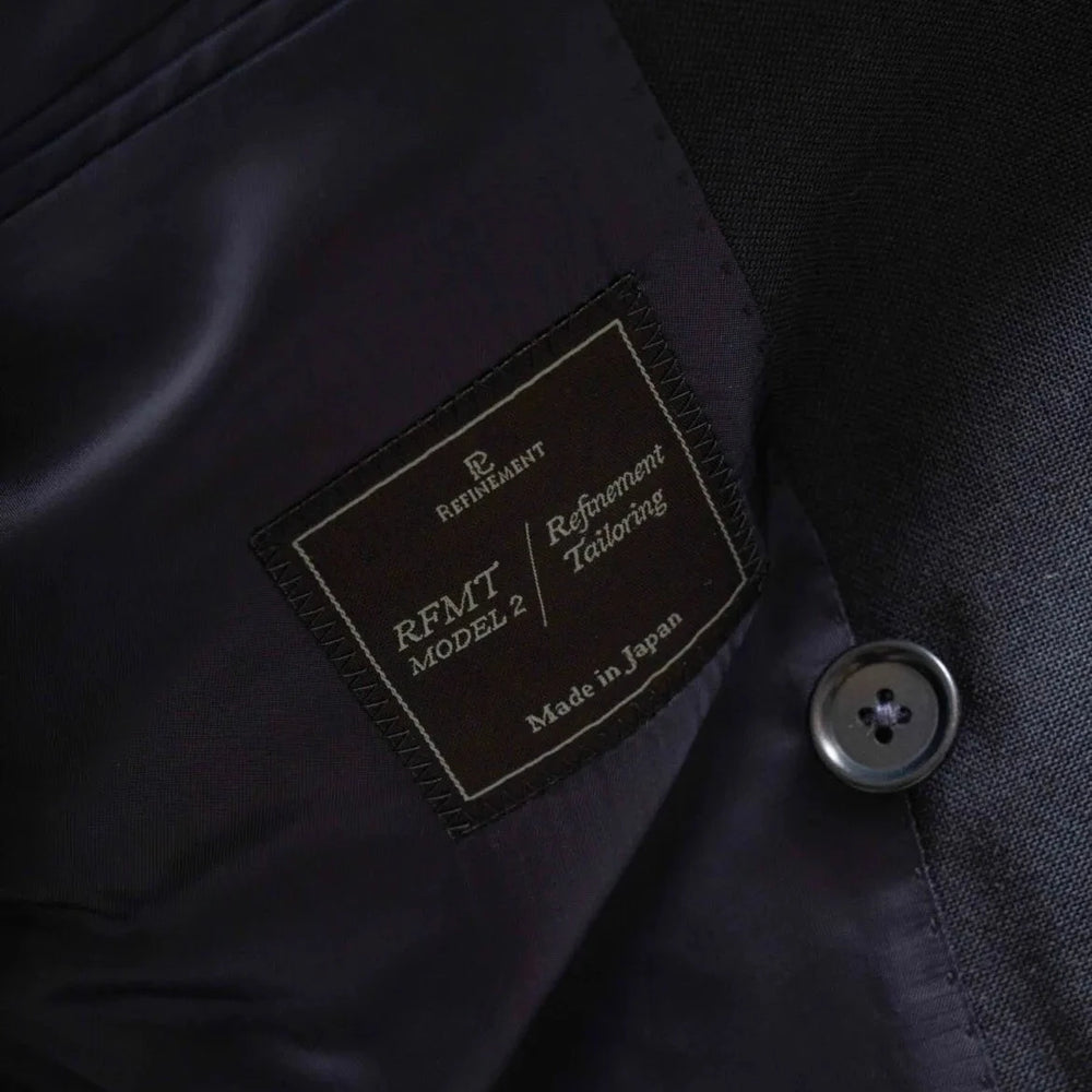 Close-up of the interior trousers label showing Refinement branding and Woodhead cloth marking.