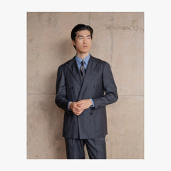 Man wearing RMJ-04 charcoal grey chalkstripe double breasted suit by Ring Jacket in a refined tailored style