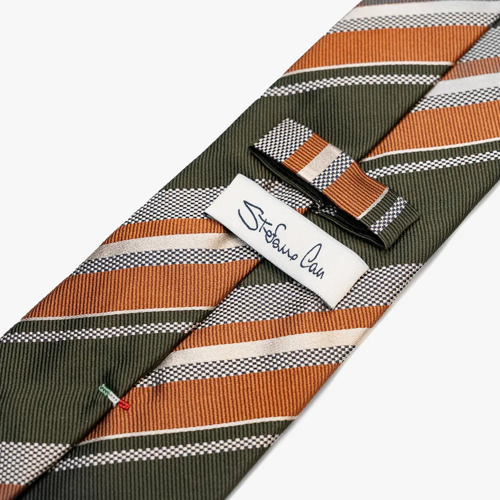 Close-up of the back side of the Stefano Cau regimental tie showing the brand label, hand-finished stitching, and clean construction.