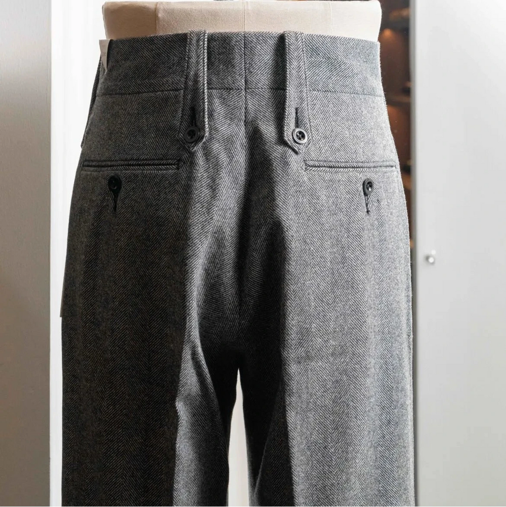 Rear view of the Tangent TAN02 Henry Hard Classic Tweed Herringbone Light Grey trousers featuring the back pockets and structured fit.