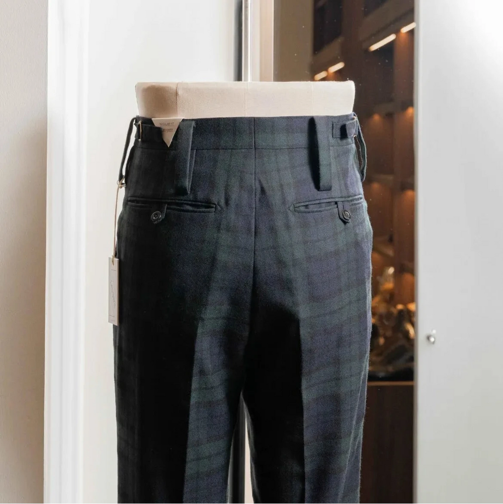 Side profile of the Tangent Tan 25° Wool Check Black Watch trousers highlighting the wool texture and clean drape.