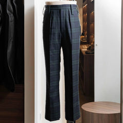 Full-length view of the Tangent Tan 25° Wool Check Black Watch trousers, showing the tailored silhouette and classic Black Watch pattern.