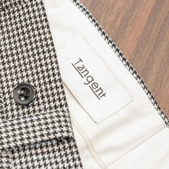 Close-up of the inner label of the Tangent Tan 25° Wool Check Hound Tooth trousers showcasing branding and craftsmanship.