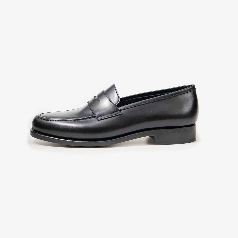 Side profile of the TLB Mallorca Goya Buckled Loafer in black hatch grain leather with a sleek silhouette and single leather sole.