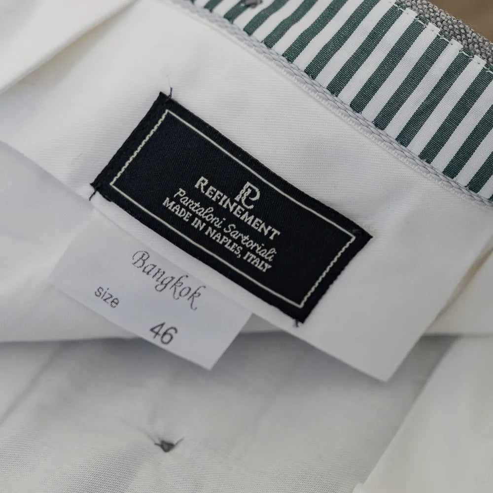 Close-up of the Refinement × Airesco label showing interior craftsmanship.