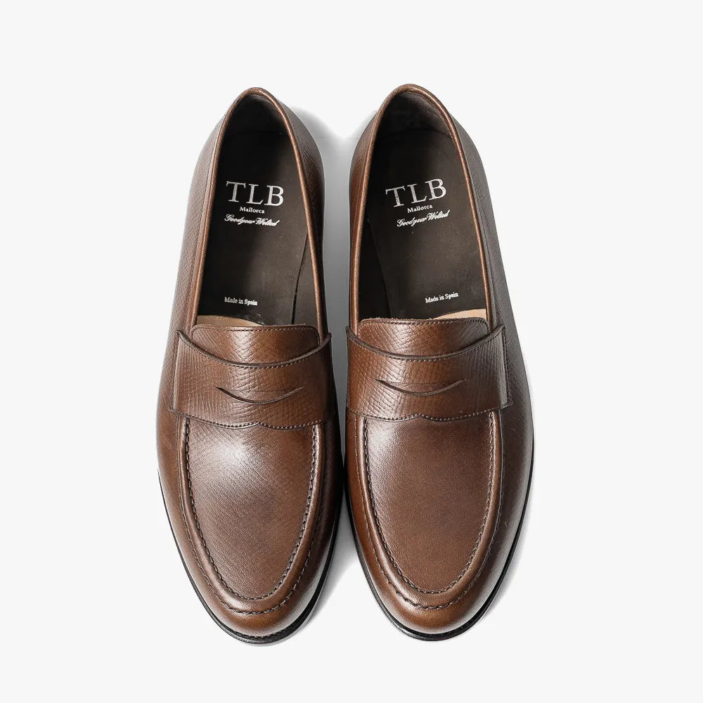 Close-up of the dark brown hatch grain leather showing embossed texture and durable finish.