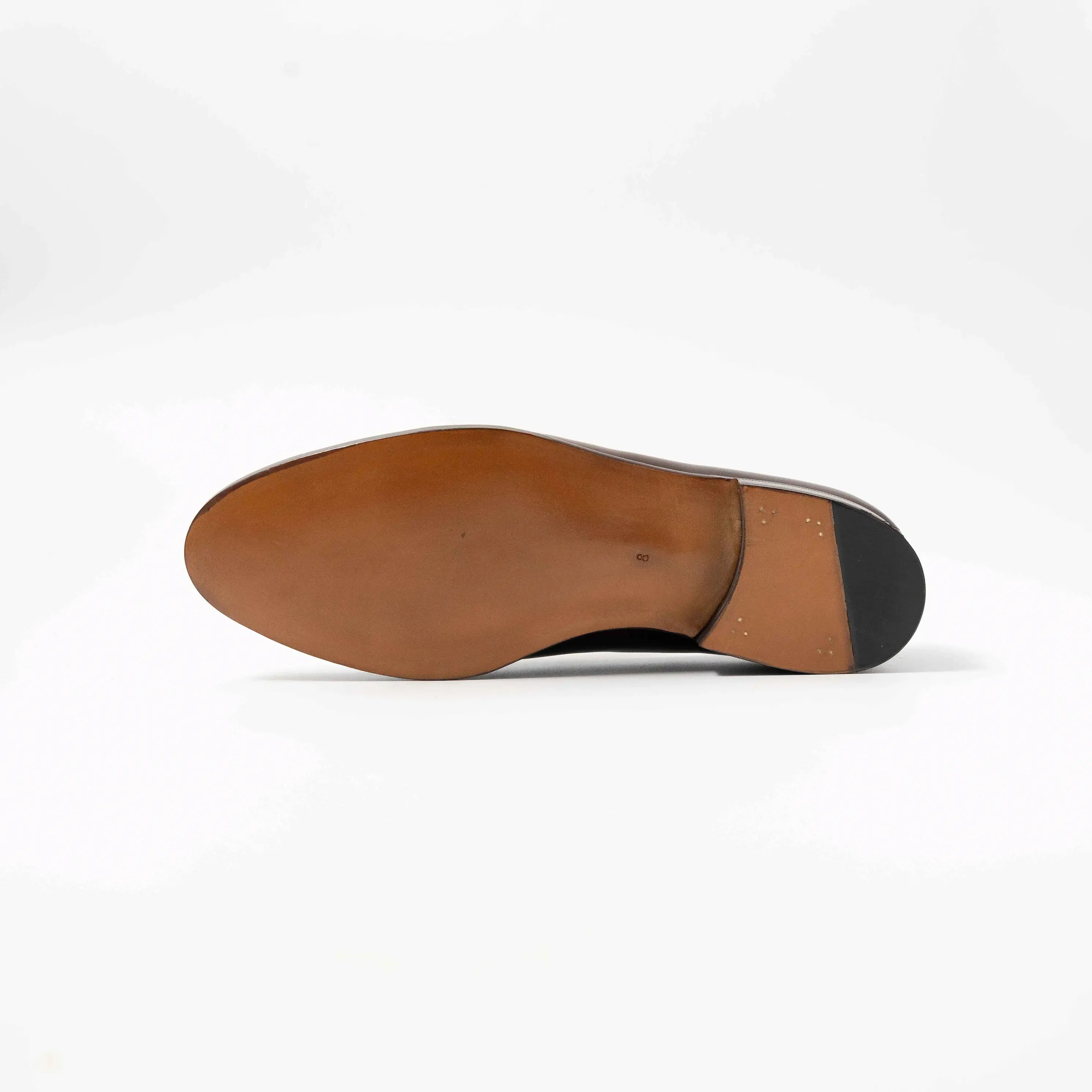 Underside view showing the single leather sole and craftsmanship of the TLB Mallorca penny loafer.