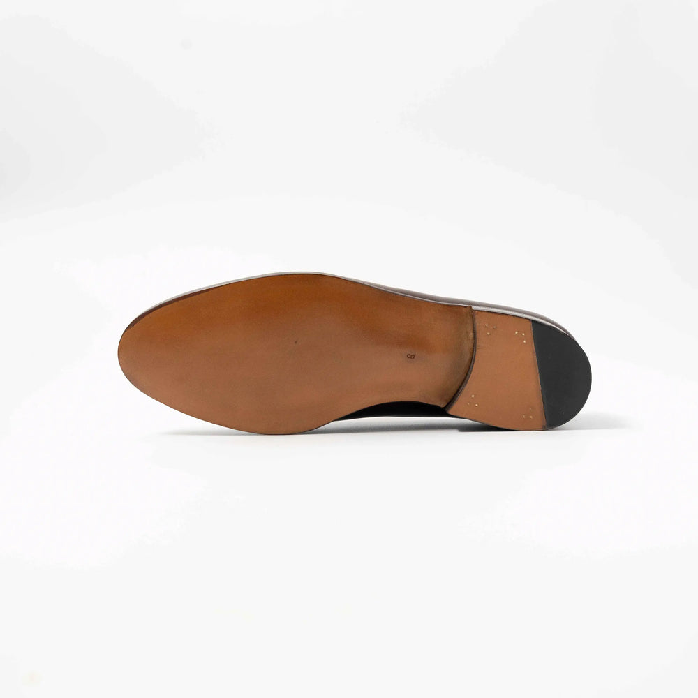 Underside view showing the single leather sole and craftsmanship of the TLB Mallorca penny loafer.