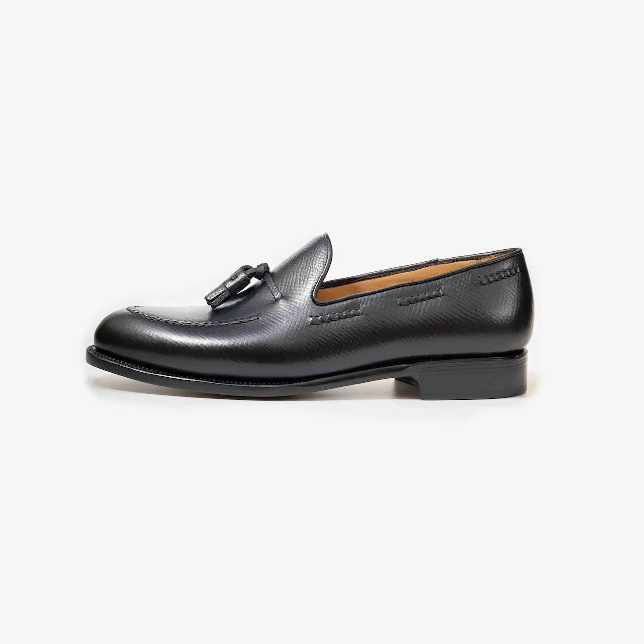 Side view of the TLB Mallorca 316 Jones Tassel Loafer in black hatch grain leather with a sleek profile and leather sole.