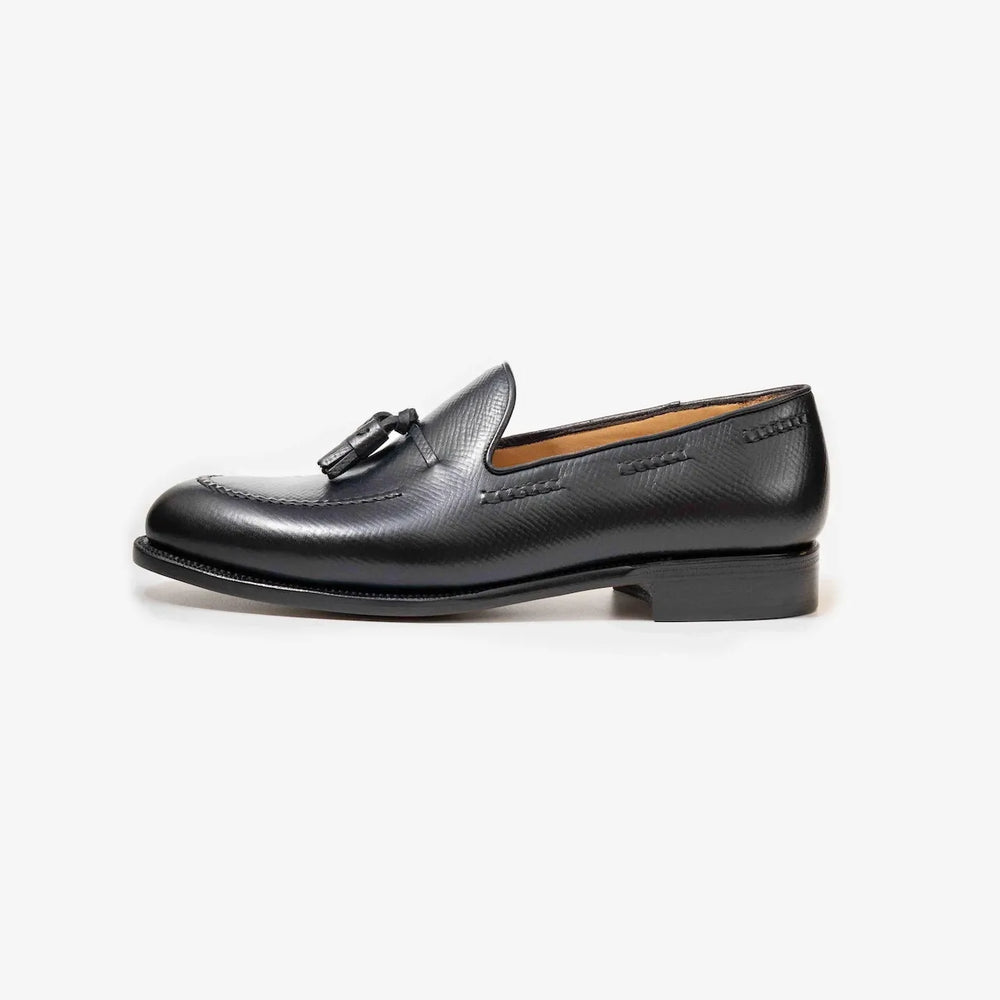 Side view of the TLB Mallorca 316 Jones Tassel Loafer in black hatch grain leather with a sleek profile and leather sole.