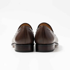 Pair of brown leather loafers on a white background