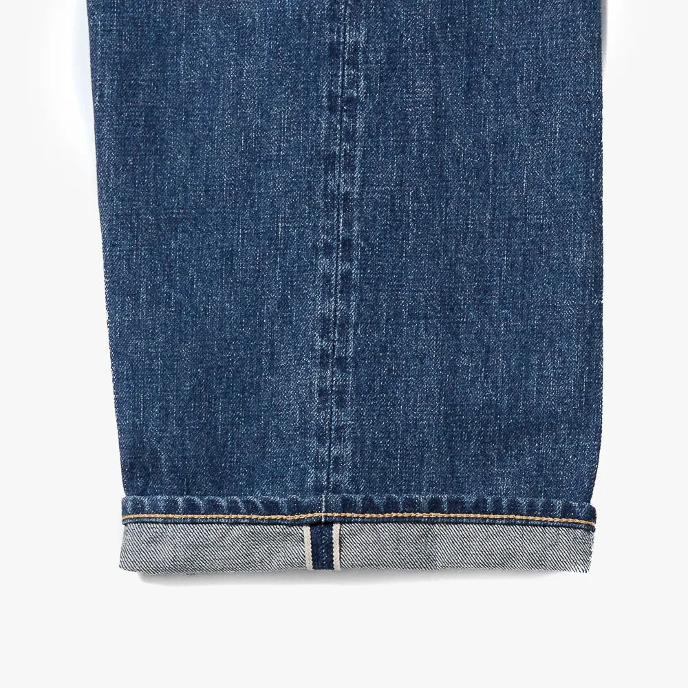 Close-up of the dark blue denim fabric showing texture, weave, and depth of color.