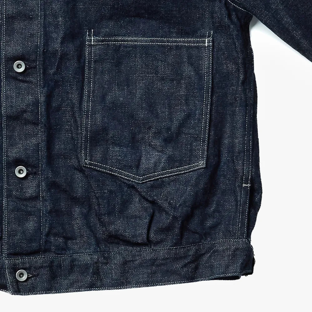 Close-up of the indigo fabric showing weave texture, depth of color, and durable vintage-inspired character.
