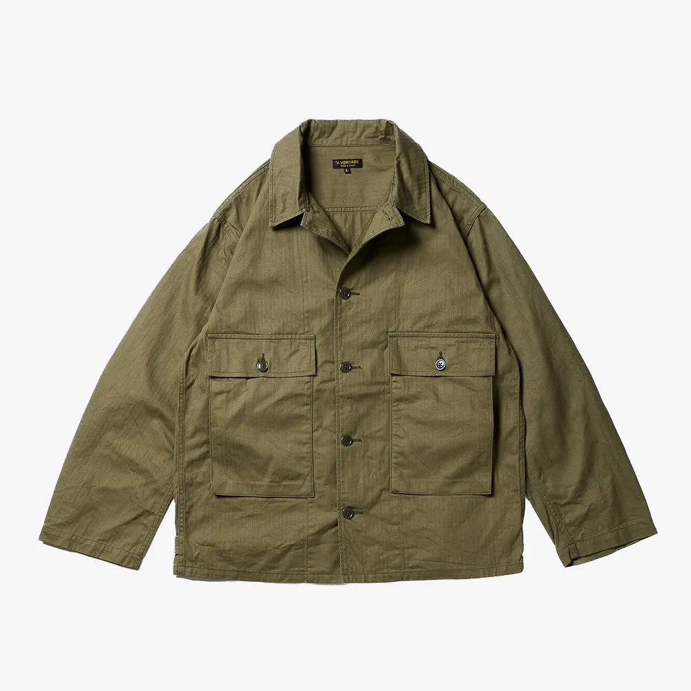 Front view of the A Vontade Naval Utility Jacket in military herringbone olive showing the naval-inspired utility design and structured silhouette.
