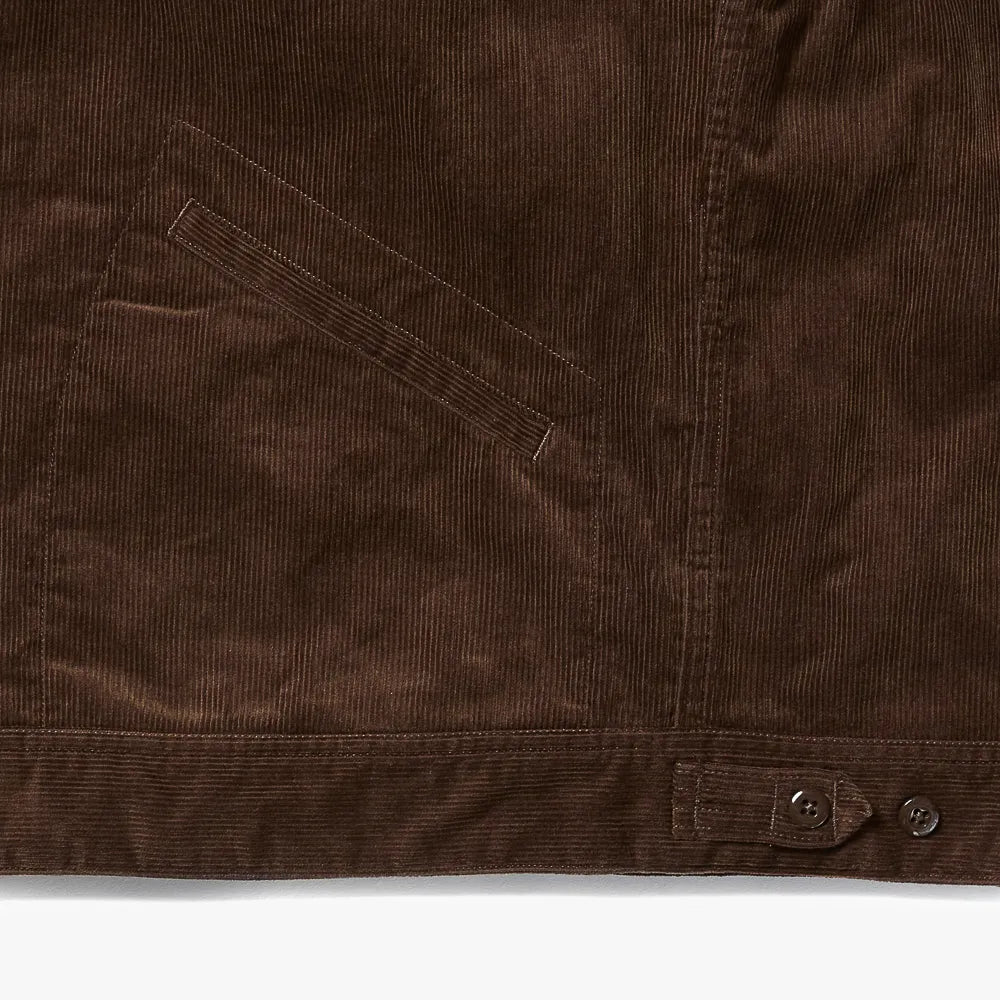 Close-up of the hem and pocket area of the A Vontade Zip Work Jacket showing stitching details and corduroy wale texture.