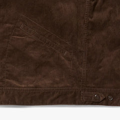 Close-up of the hem and pocket area of the A Vontade Zip Work Jacket showing stitching details and corduroy wale texture.