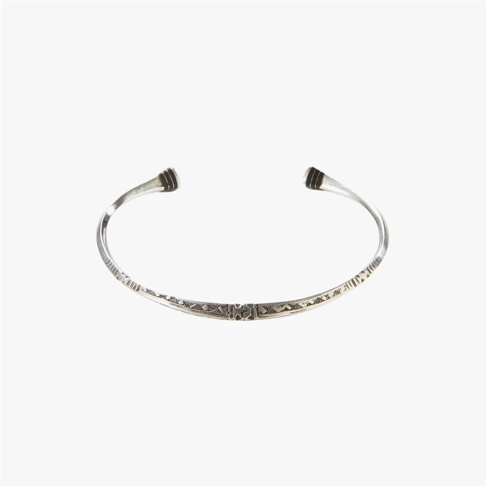 Full view of the Adawat’n Tafoukt Bracelet showing the handcrafted metal form and distinctive geometric design.