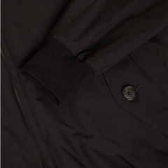 Close-up of the flap pocket showing button closure and refined stitching.