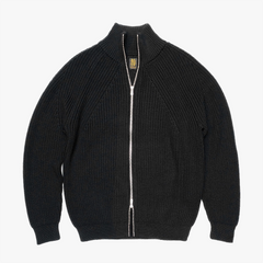 Front view of the Batoner Signature Drivers Knit Jacket in Black, showing its dense structured knit, clean silhouette, and two-way zipper.