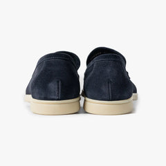 Close-up of the heel block showing stacked construction, stitching, and structured shaping.