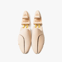 Side view highlighting the contoured shape designed to maintain shoe structure.