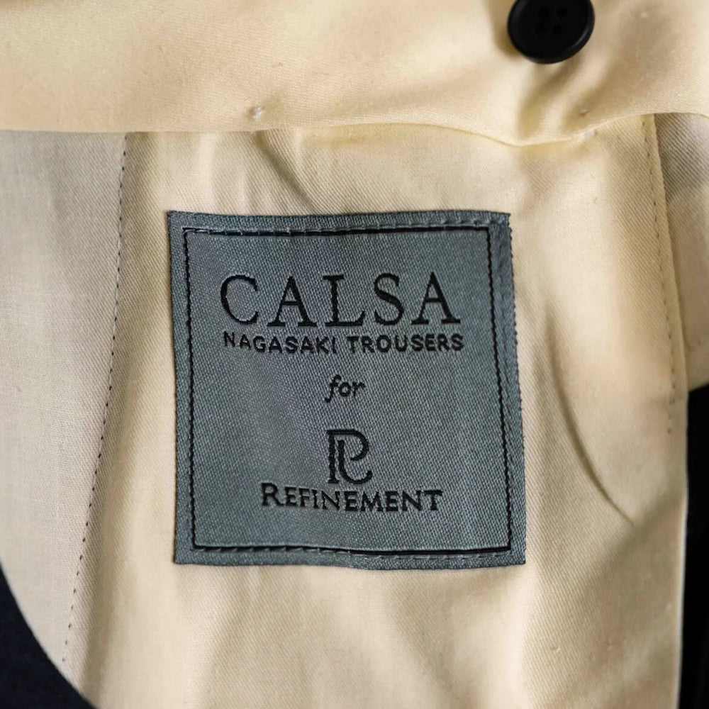 Brand label detail of the Calsa Nagasaki Trousers Beige