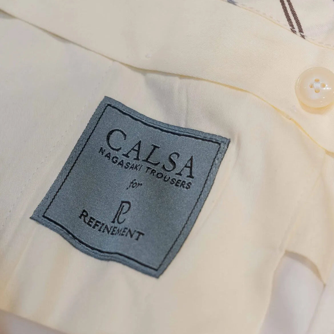 Brand label detail of the Calsa Nagasaki Trousers Cotton Beige