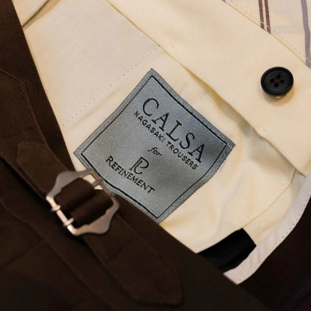Brand label detail of the Calsa Nagasaki Trousers Cotton Dark Brown